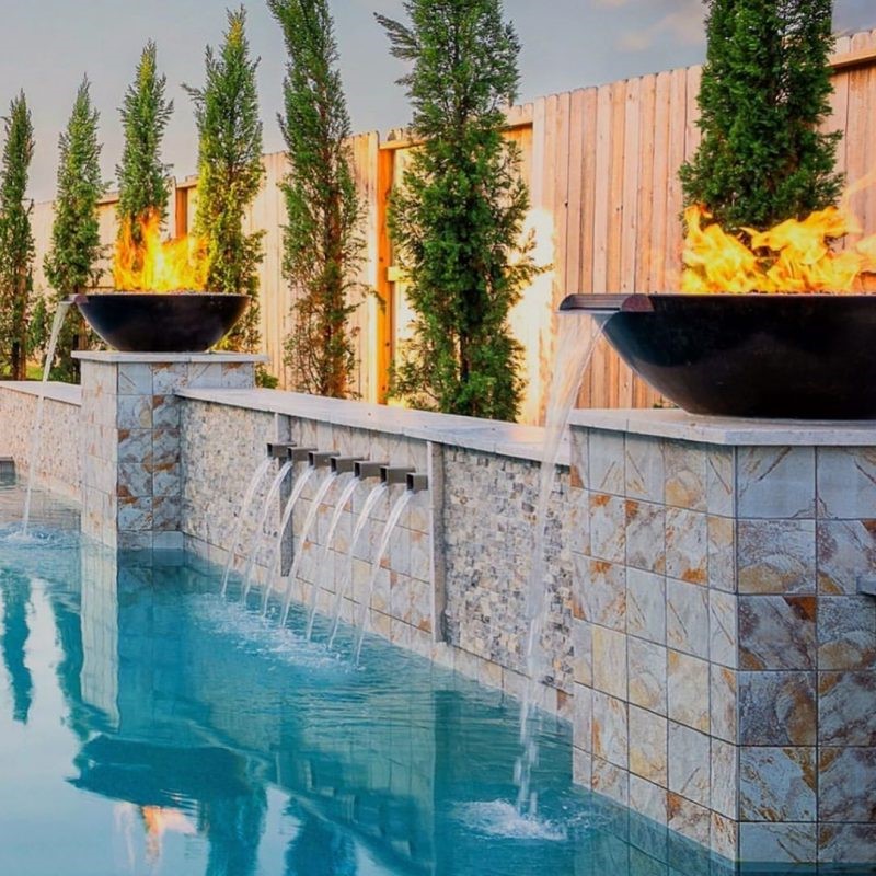 ire bowls on a pool's water feature wall