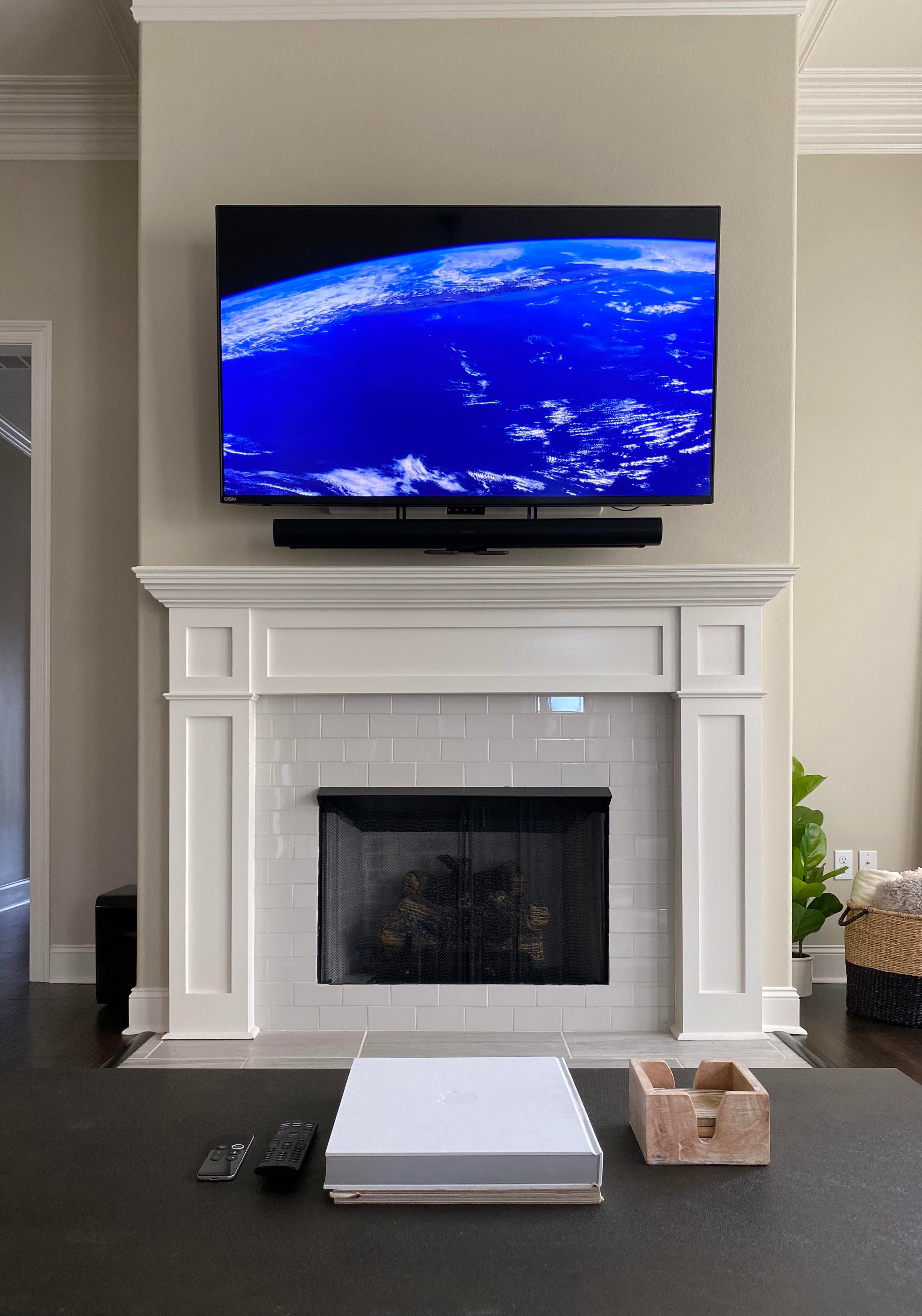 TV wall mount installation with wire concealment over fireplace