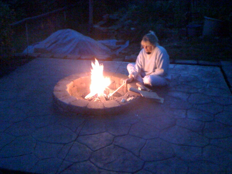 Woman enjoying the warmth of a fire pit