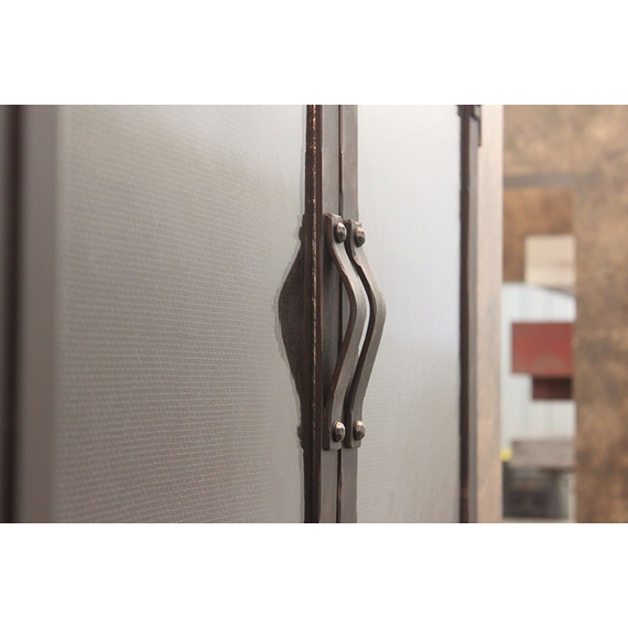Handles on the Old World masonry fireplace door are mounted on the centar bars of the cabinet doors.