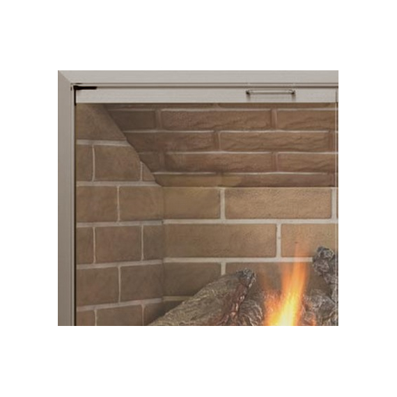 Corner detail of Huntress glass fireplace door with anodized Brushed Brass finish