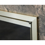 Corner detail of Huntress glass fireplace door with anodized Brushed Brass finish