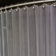 Brite Aluminum Serenity mesh shower curtain shown with optional ball hooks and curved shower rod