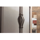 Handles on the Old World masonry fireplace door are mounted on the centar bars of the cabinet doors.