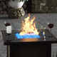 The Outdoor Plus Tempered Wind Guard on top of Fire Pit